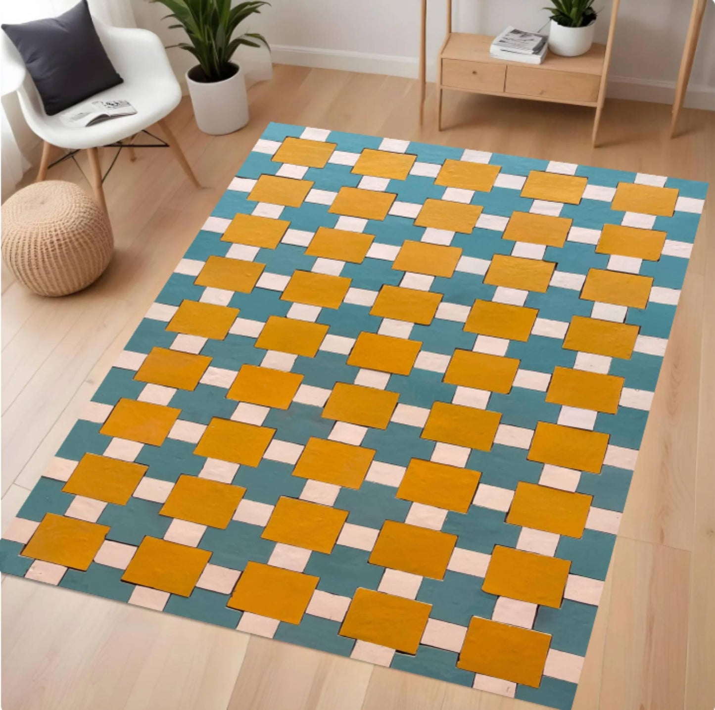 A rectangular area rug with a geometric interlocking block pattern in teal blue, mustard yellow, and light pink, shown on a light wood floor in a modern living room setting.