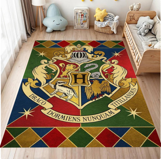 A large rectangular area rug featuring the Hogwarts crest from Harry Potter, displayed on a light wood floor in a child's bedroom setting.