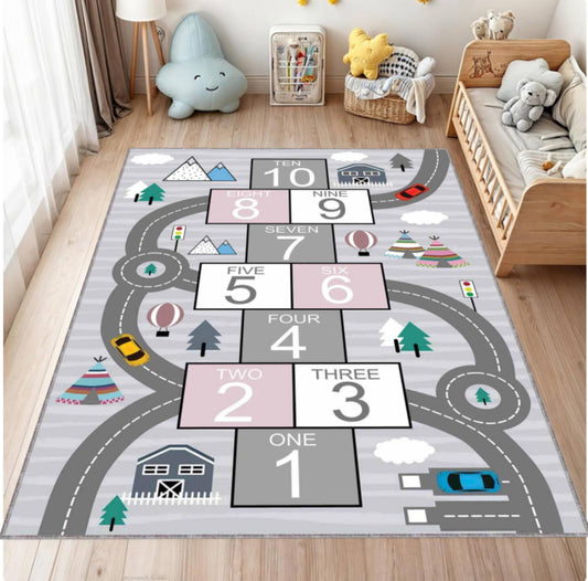 Children's play rug with numbers and road design in a room with toys and furniture.
