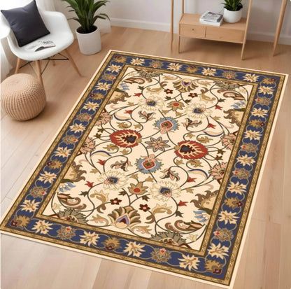 Decorative floral rug on a wooden floor with a chair and plants in the background