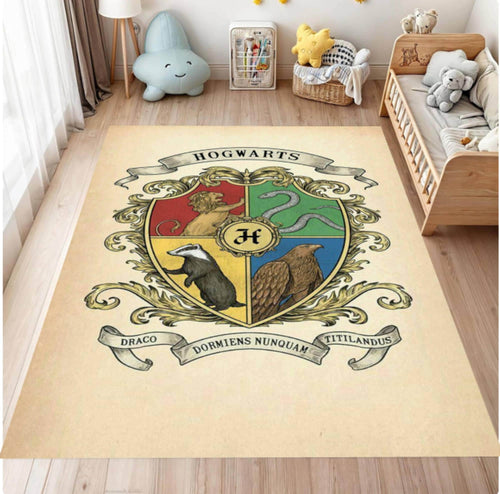 A large cream-colored area rug featuring the Hogwarts crest from Harry Potter, styled in a child's bedroom next to a wooden toddler bed and toys.
