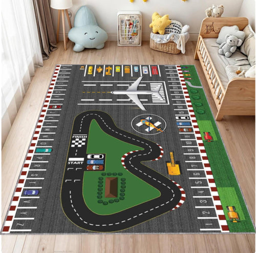 Children's play rug with race track and airport design in a room with toys and furniture.