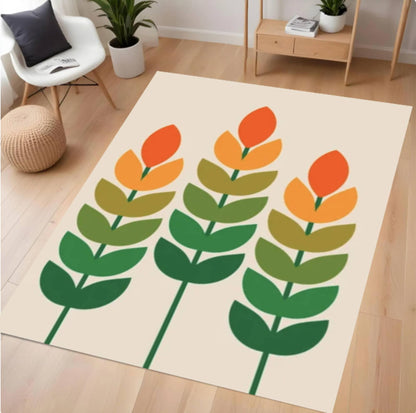 Decorative rug with green and orange floral design on a wooden floor.