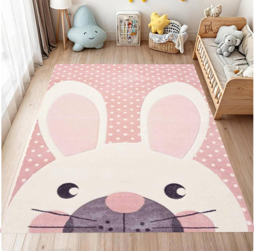 Children's room with a pink cartoon rug featuring a face design.