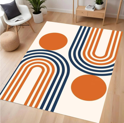 Decorative rug with orange and blue abstract design on a wooden floor.
