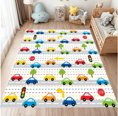 Children's room with a colorful rug featuring cars and traffic lights.