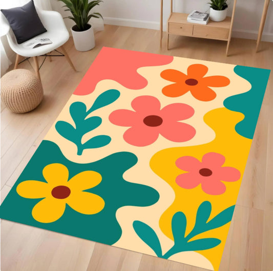 A rectangular area rug with a retro 1960s-style floral pattern in yellow, orange, pink, teal, and cream, styled on a light wood floor in a modern living room setting.