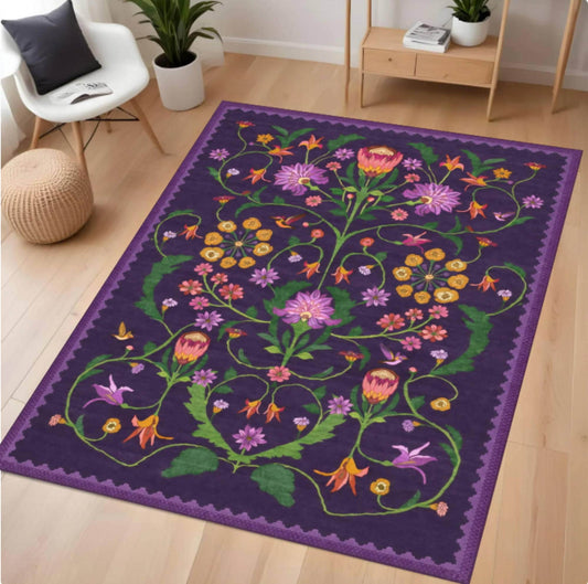 Decorative rug with floral patterns on a wooden floor in a room.