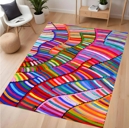 A colorful area rug with a vibrant, multicolored wavy stripe pattern, shown in a modern living room setting with light wood floors and neutral-toned furniture.