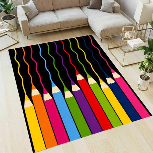 A rectangular area rug with a colorful pencil design is shown on a light wood floor in a modern living room setting with a beige sectional sofa and glass tables.
