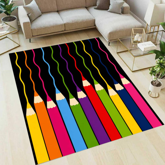 A rectangular area rug with a colorful pencil design is shown on a light wood floor in a modern living room setting with a beige sectional sofa and glass tables.