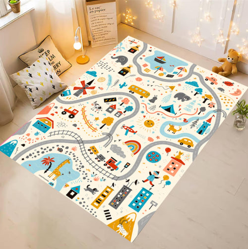 A large rectangular children's play rug with a whimsical road and city map design, styled in a bright, modern nursery setting with toys, pillows, and string lights.