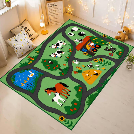 A rectangular children's play rug with a farm road scene, shown in a styled room. The rug features a green background with winding gray roads, illustrated animals including cows, a horse, sheep, ducks, and a pig, a blue pond, and a red tractor.