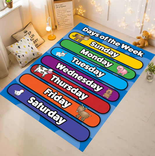 A colorful children's rug laid on a light wood floor in a styled room. The rug shows the days of the week in large rounded color blocks with cartoon animals and white text reading Sunday through Saturday.