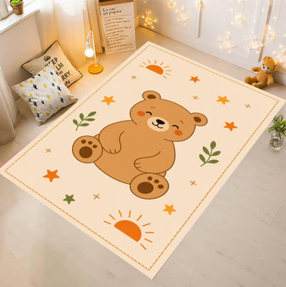 A rectangular cream-colored nursery rug with a cartoon brown bear sitting in the center, surrounded by small stars, leaves, and sun motifs, shown in a styled child's room setting.