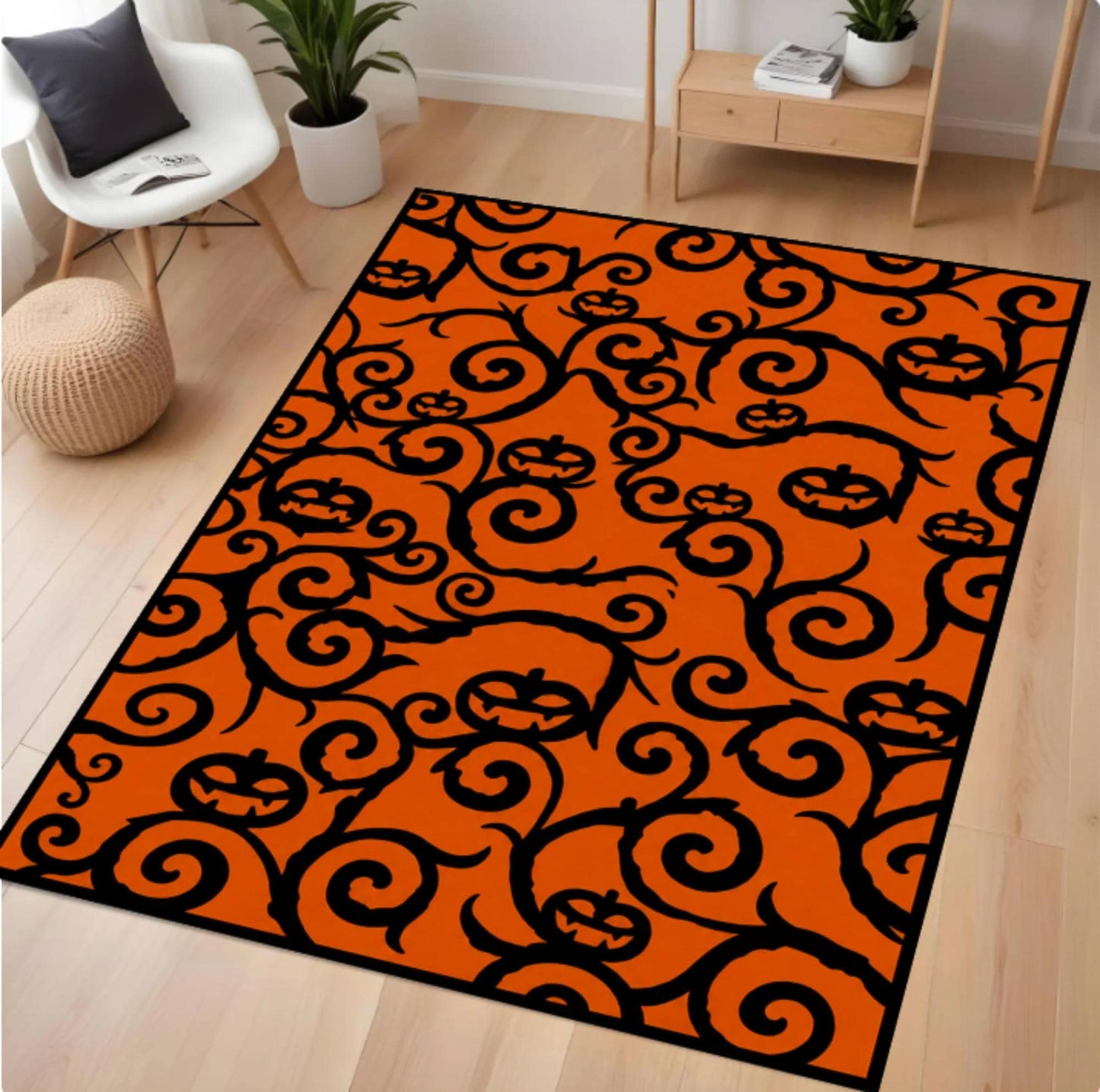 An orange and black patterned area rug with a Halloween theme, featuring black pumpkins and swirling vines on an orange background, shown in a modern living room setting.