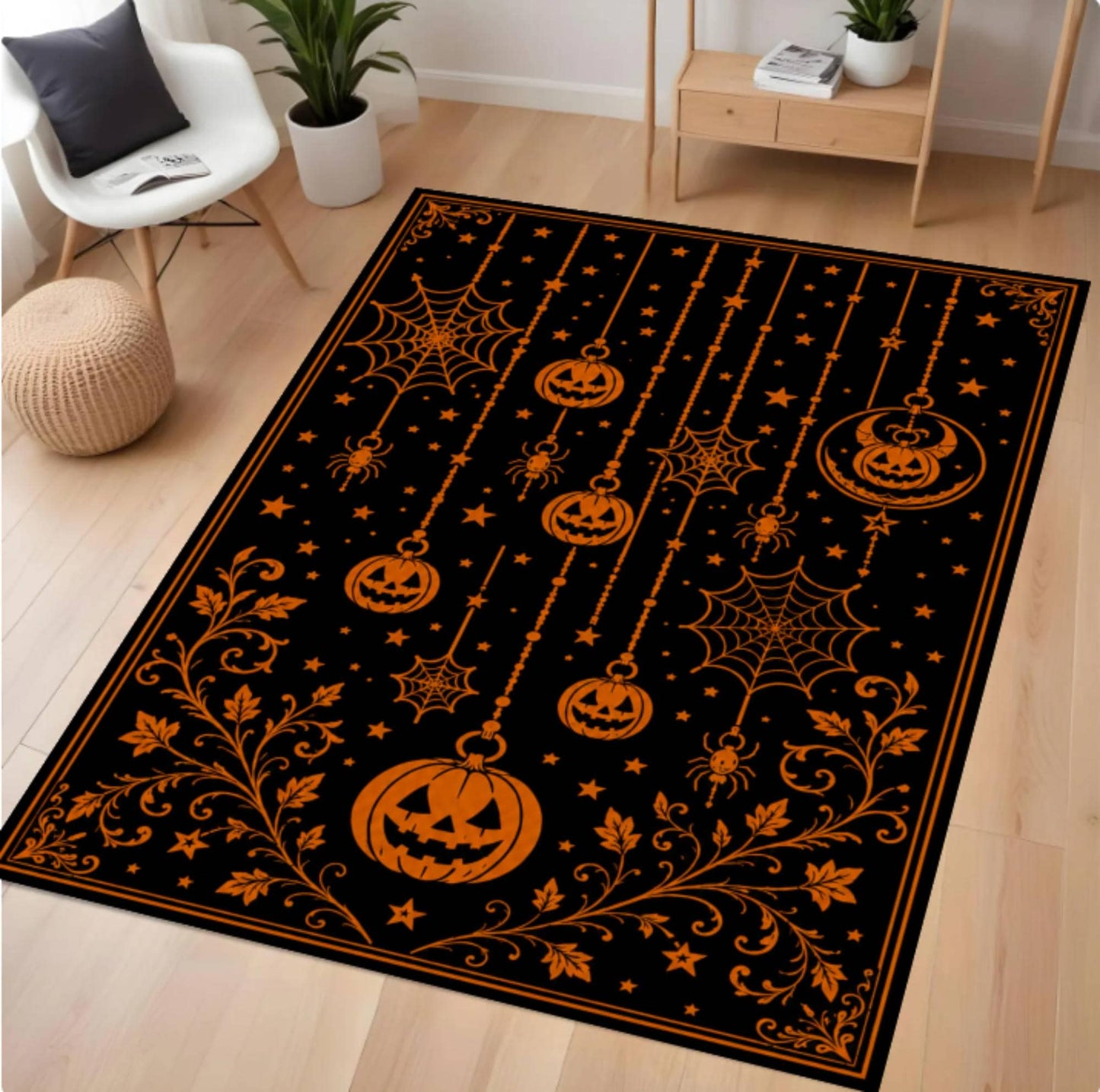 A rectangular black area rug with an orange Halloween design, featuring jack-o'-lanterns, spiders, webs, and stars, shown on a light wood floor in a styled room.