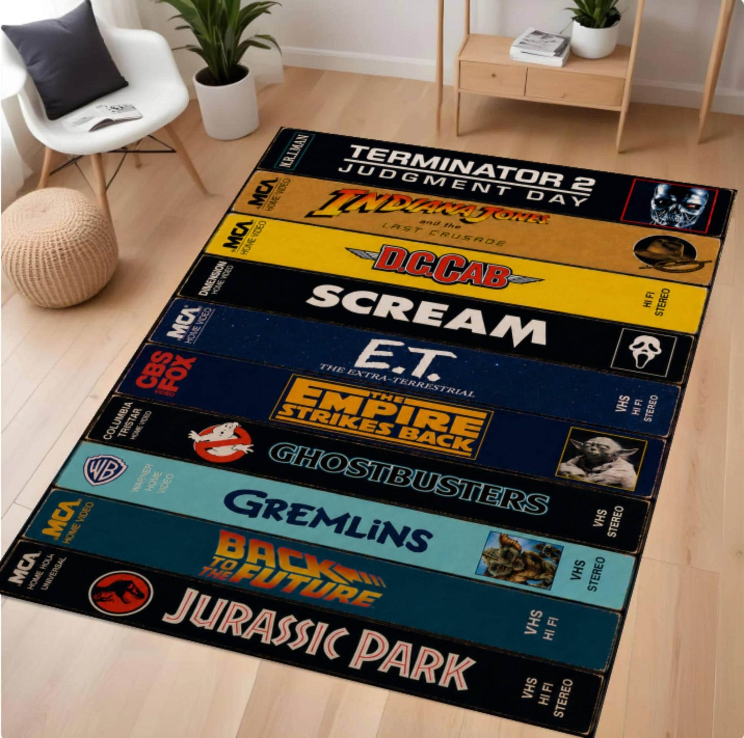 A long rectangular area rug laid on a light wood floor in a styled room, featuring stacked VHS tape designs with pop culture movie and franchise graphics including Terminator 2, Alien, Scar, Scream, E.T.