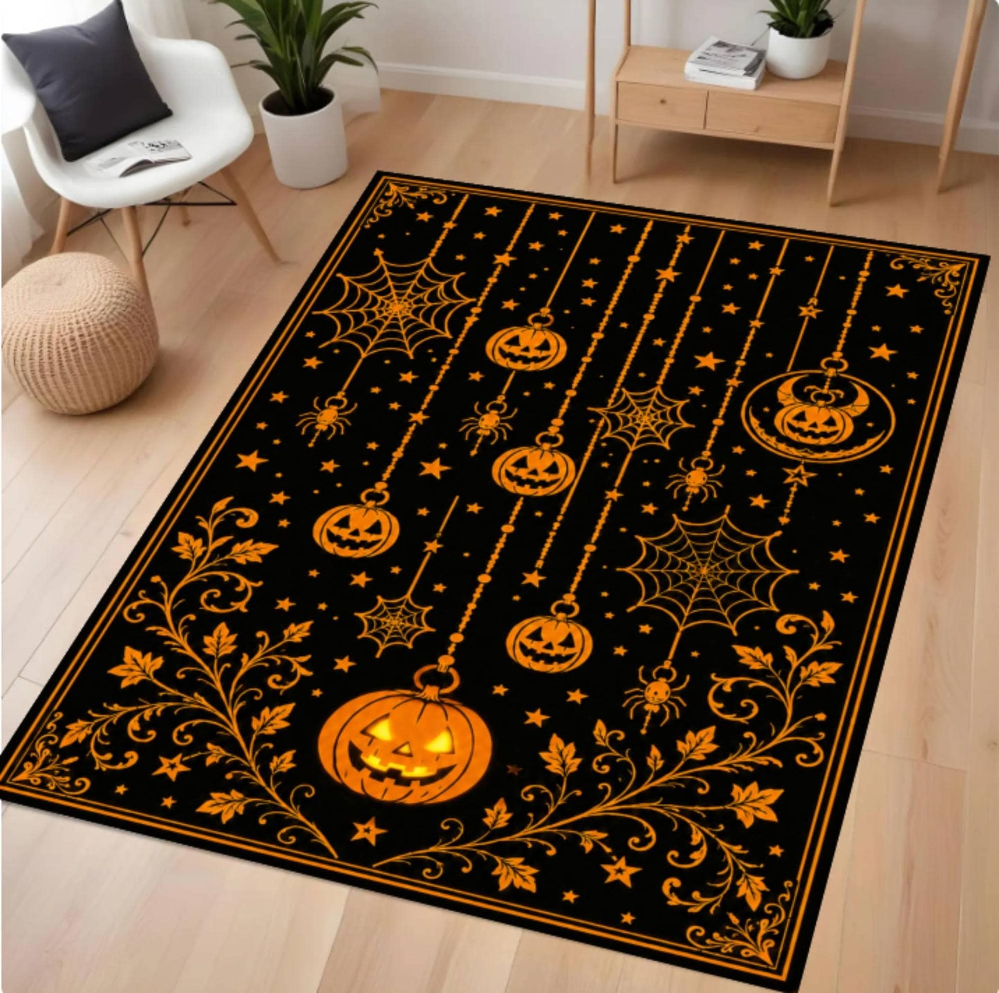A rectangular black area rug with a Halloween design, featuring orange jack-o'-lanterns, spiderwebs, stars, and floral vines, shown on a light wood floor in a styled room.