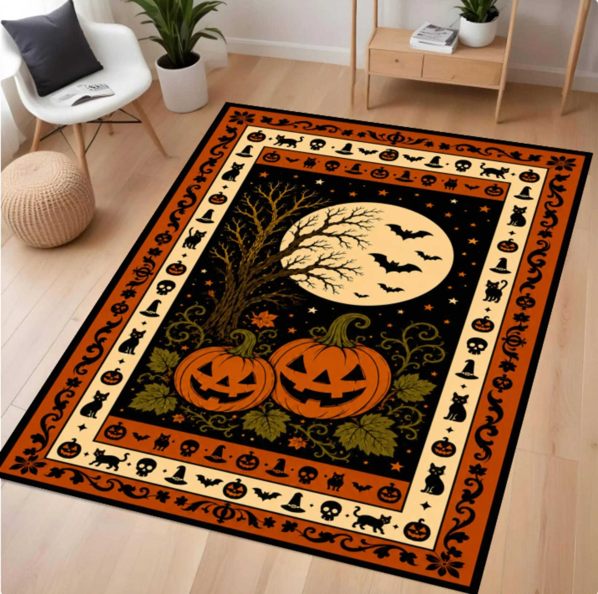 A rectangular Halloween-themed area rug displayed on a light wood floor in a modern living room setting. The rug features a black background with a large cream-colored moon, two carved orange pumpkins, a bare tree, bats, and a decorative border with skulls, cats, and other spooky motifs.
